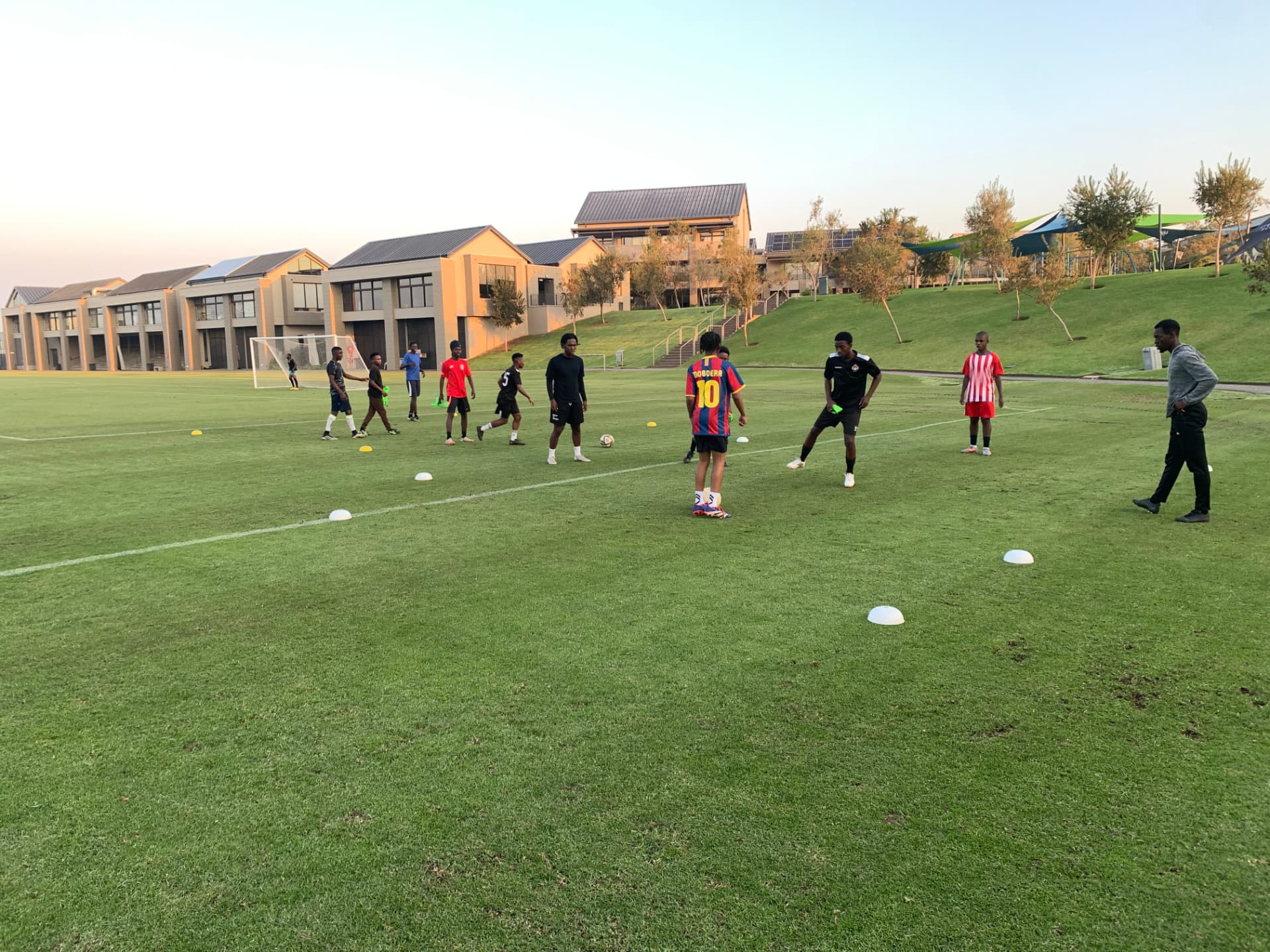 TCFSA player training under floodlights at dusk
